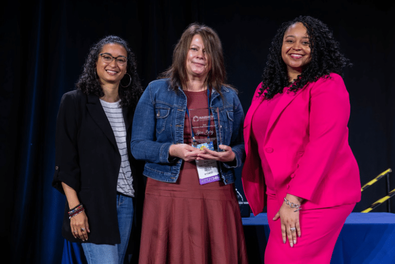 Schoolkids raising their hands in classroom