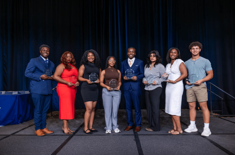 Schoolkids raising their hands in classroom